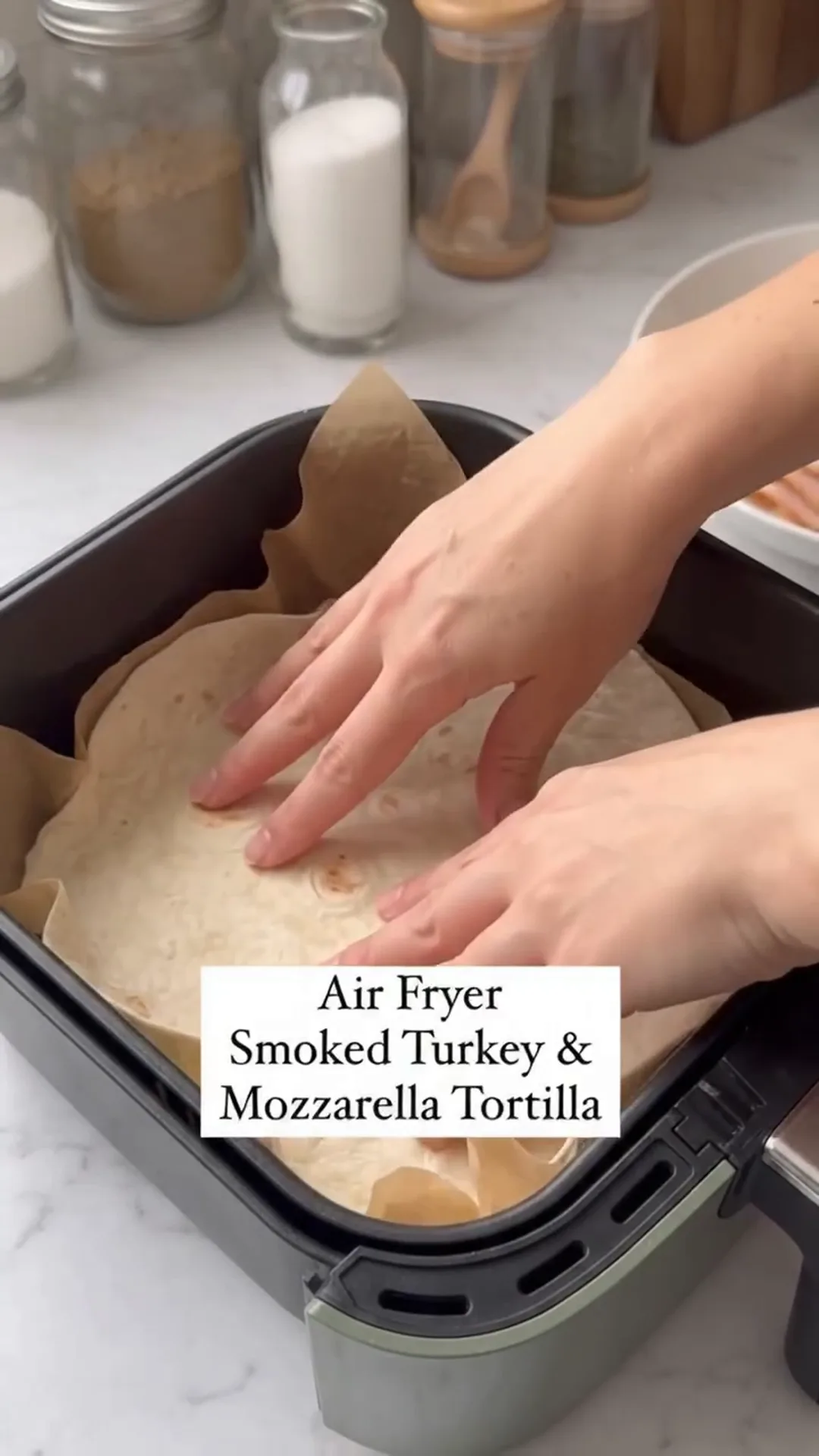 Air Fryer Smoked Turkey, Tomato & Mozzarella Tortilla – placing tortillas in an air fryer basket