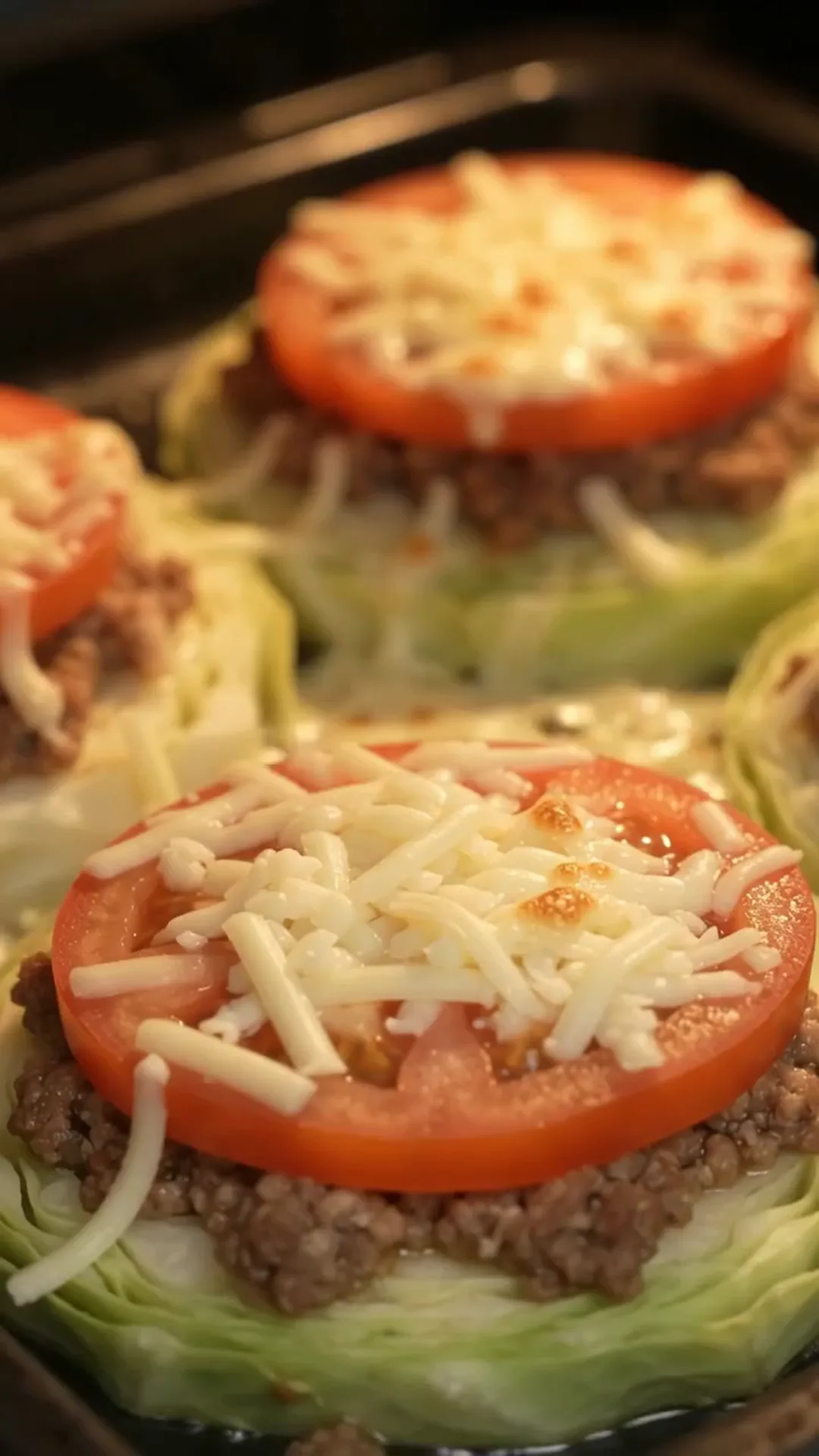 Baked Cabbage Steaks with Ground Beef, Tomato and Cheese – Preparing food in an oven
