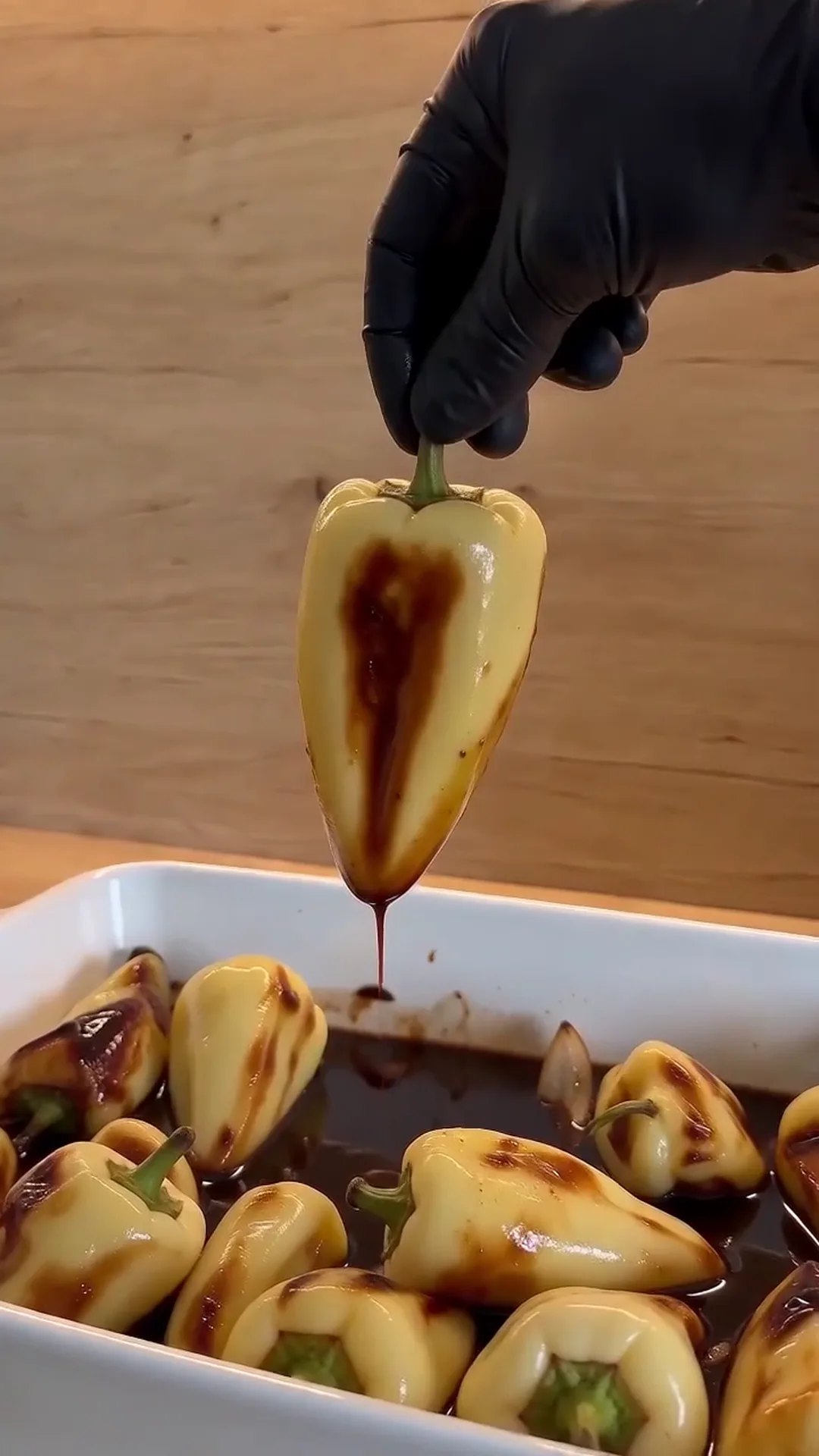 Blistered Caribe Chiles in Citrus Soy Marinade – pepper being drizzled with sauce