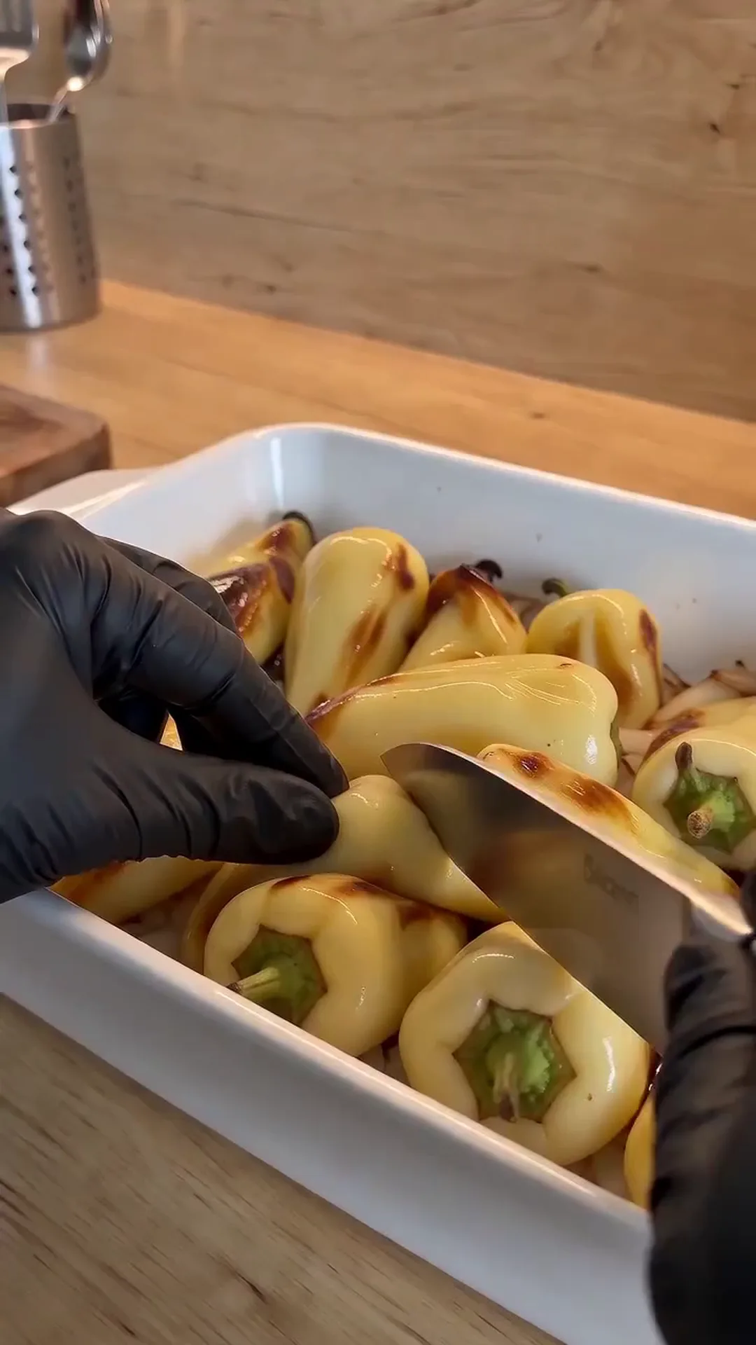 Blistered Caribe Chiles in Citrus Soy Marinade – peppers being scooped out of a baking dish