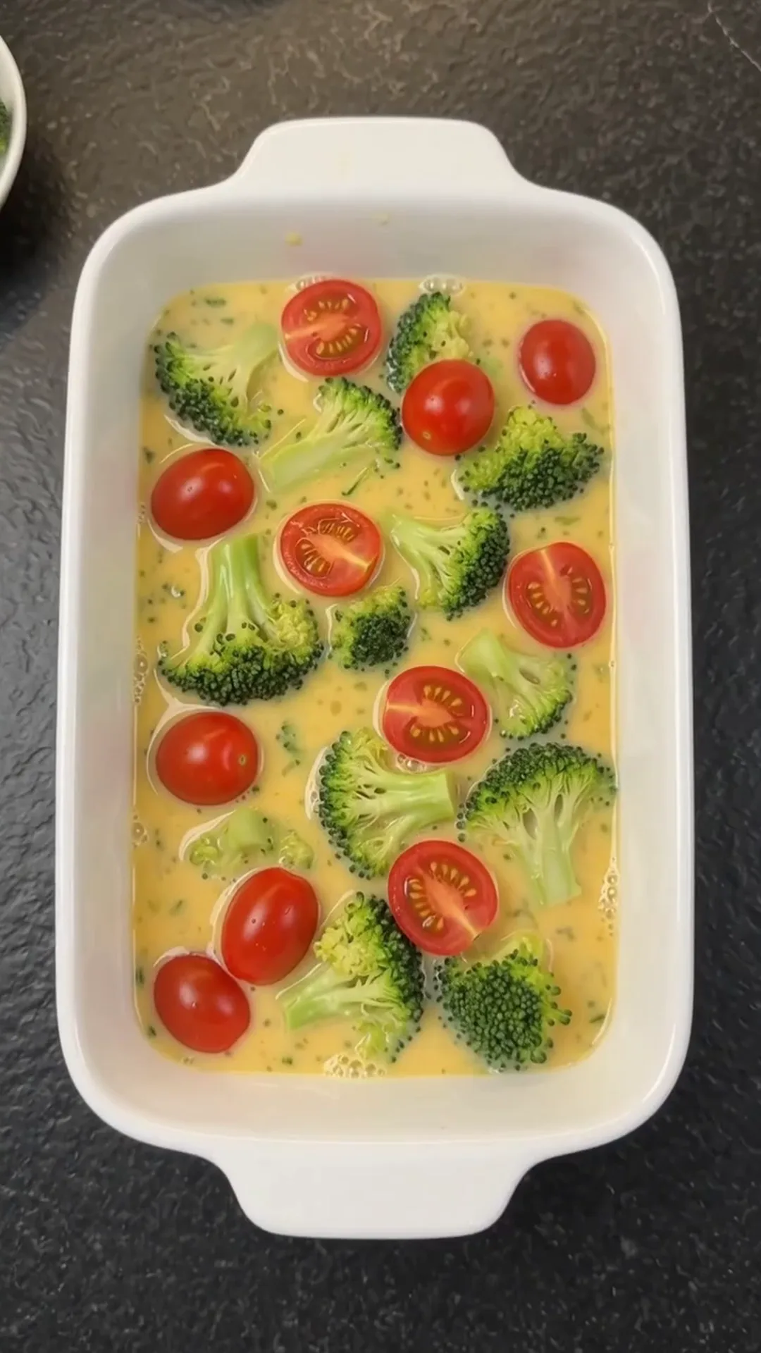Cheesy Broccoli Meat Stacks with Roasted Cauliflower – Preparing a dish with broccoli, tomatoes, and eggs