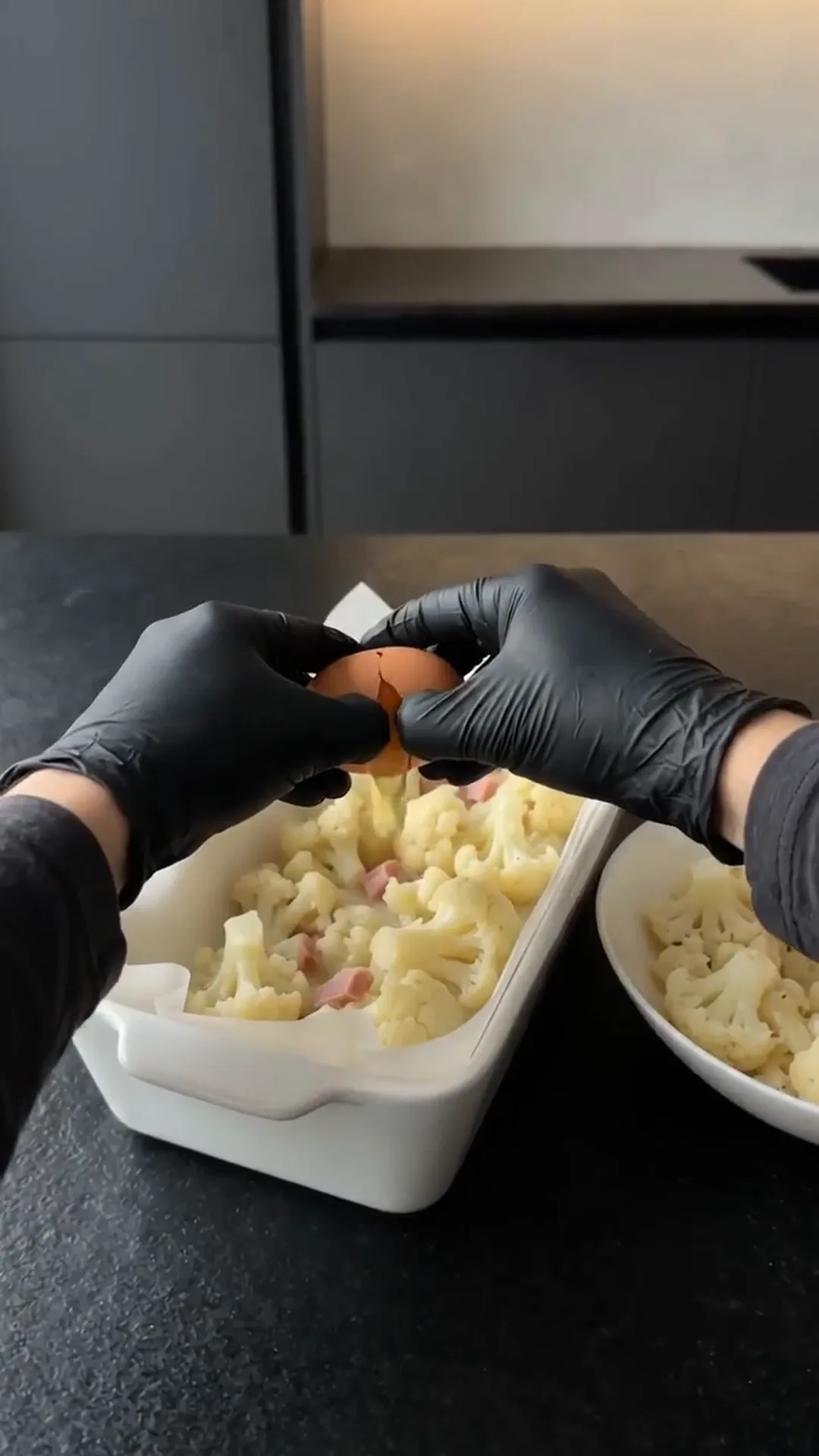 Cheesy Cauliflower and Smoked Turkey Casserole Bake – peeling an egg, hands in black gloves
