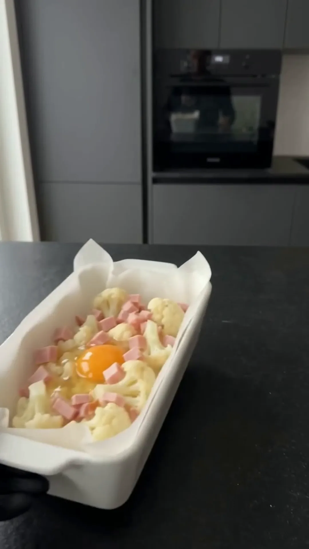 Cheesy Cauliflower and Smoked Turkey Casserole Bake – Preparing a dish with cauliflower, smoked turkey, and egg