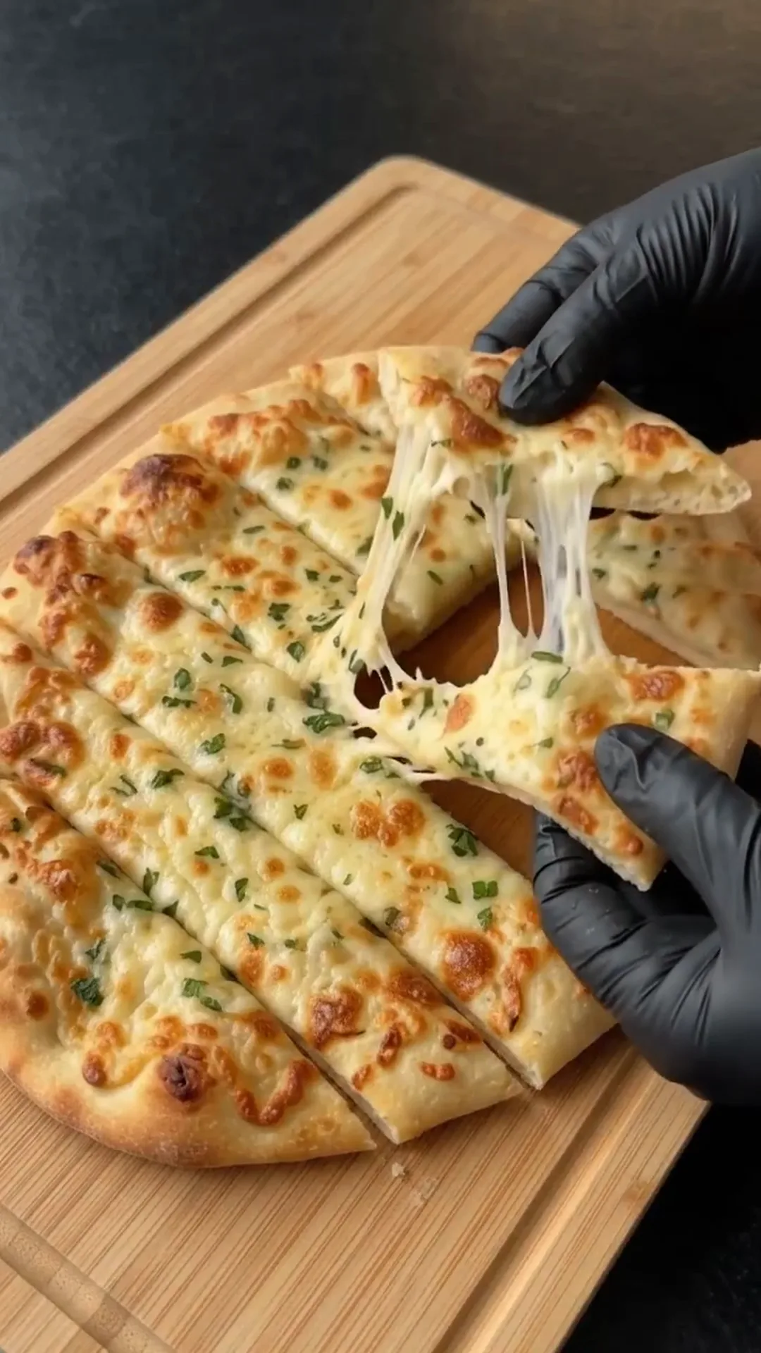 Cheesy Garlic Herb Flatbread Strips Recipe – pulling apart a cheesy flatbread