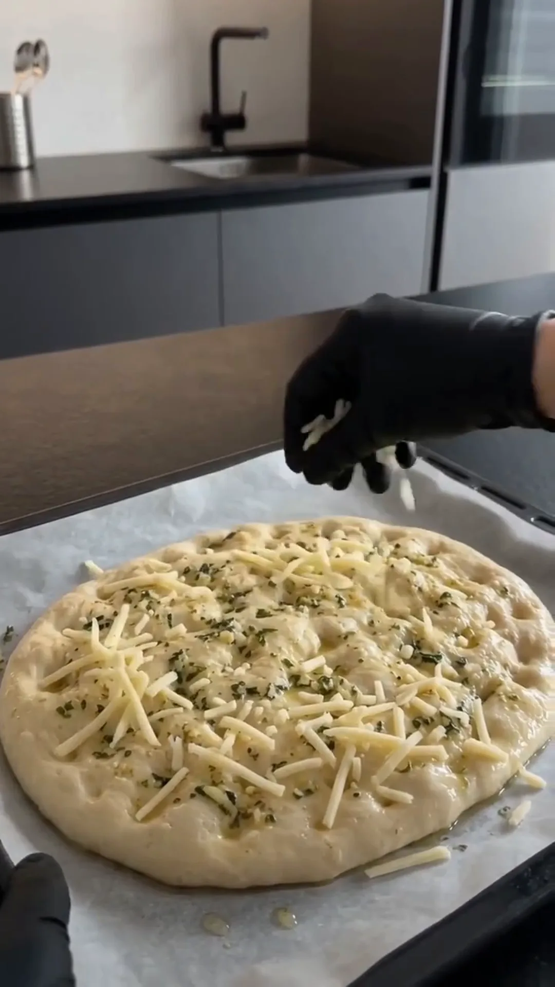 Cheesy Garlic Herb Flatbread Strips Recipe – adding cheese to a pizza