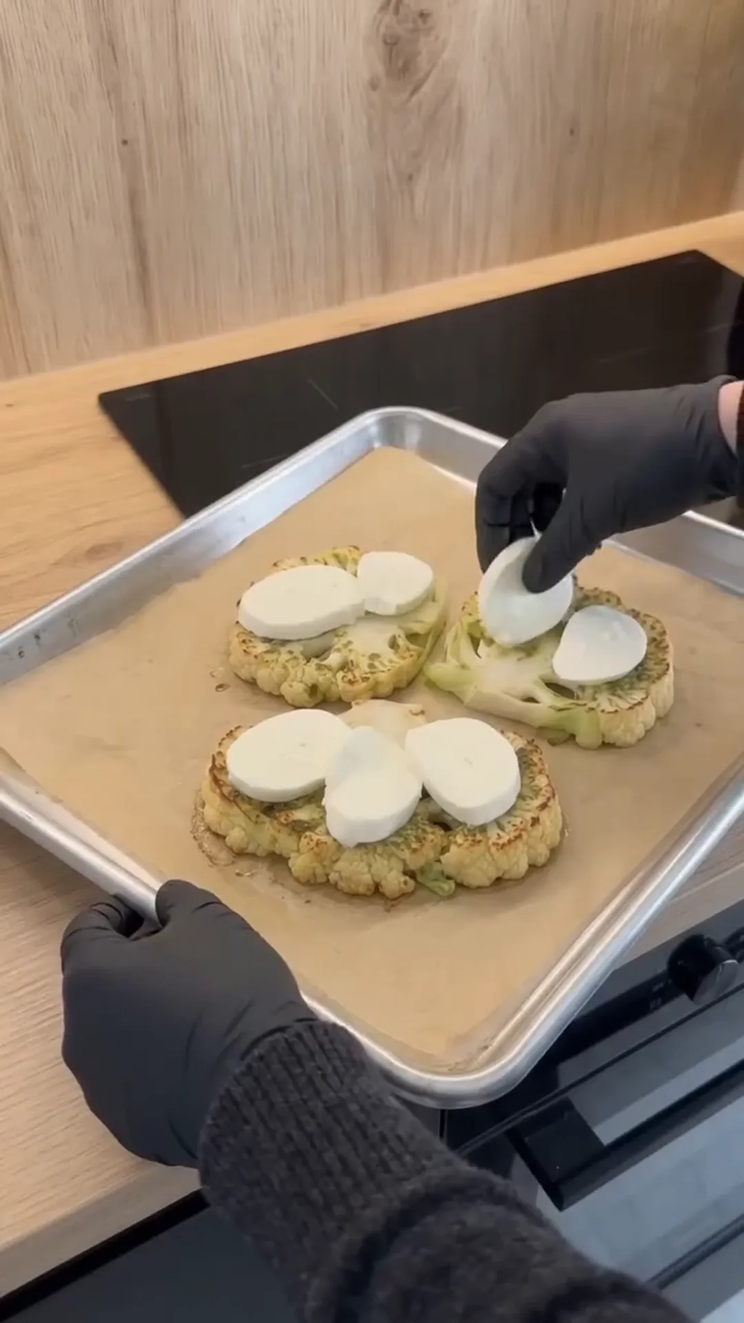 Cheesy Pesto Caprese Cauliflower Steaks – placing cheese on cauliflower steaks