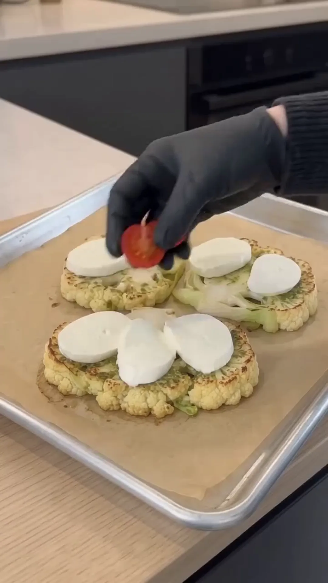 Cheesy Pesto Caprese Cauliflower Steaks – Adding toppings to roasted cauliflower steaks