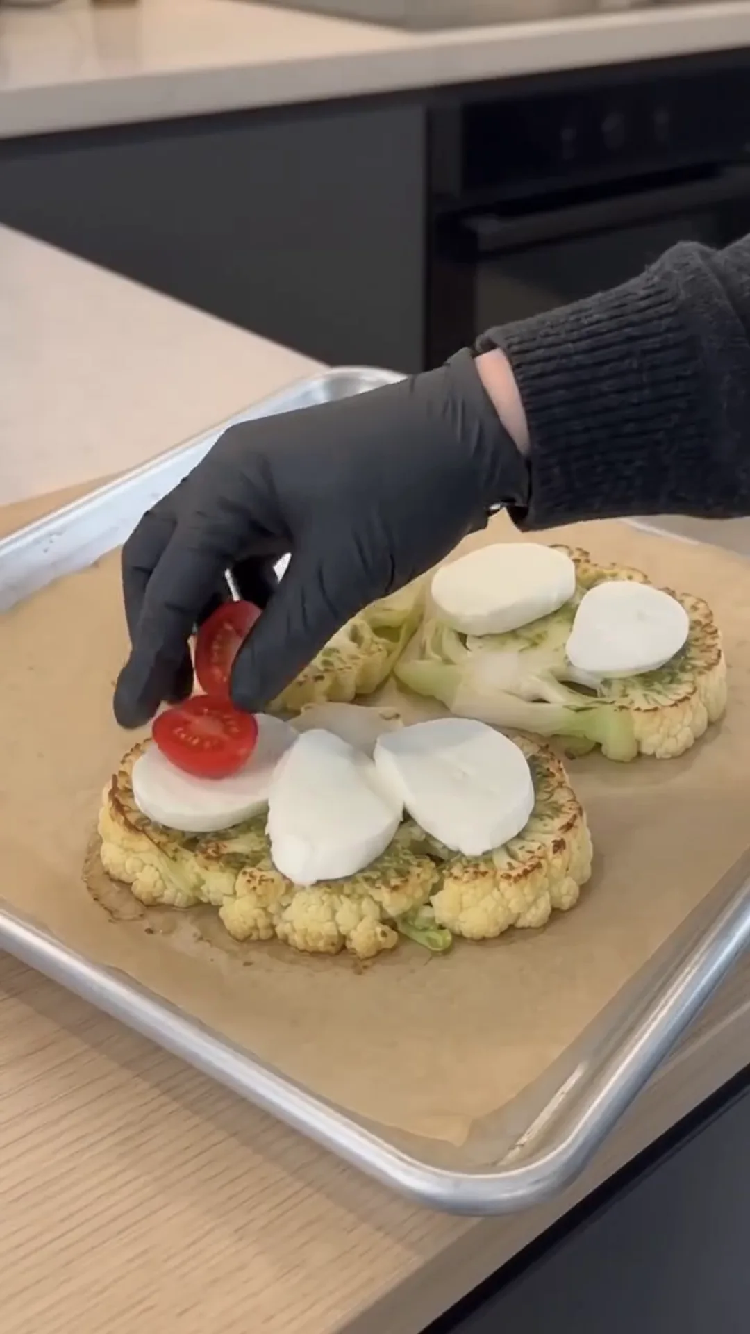 Cheesy Pesto Caprese Cauliflower Steaks – Adding toppings to roasted cauliflower steaks