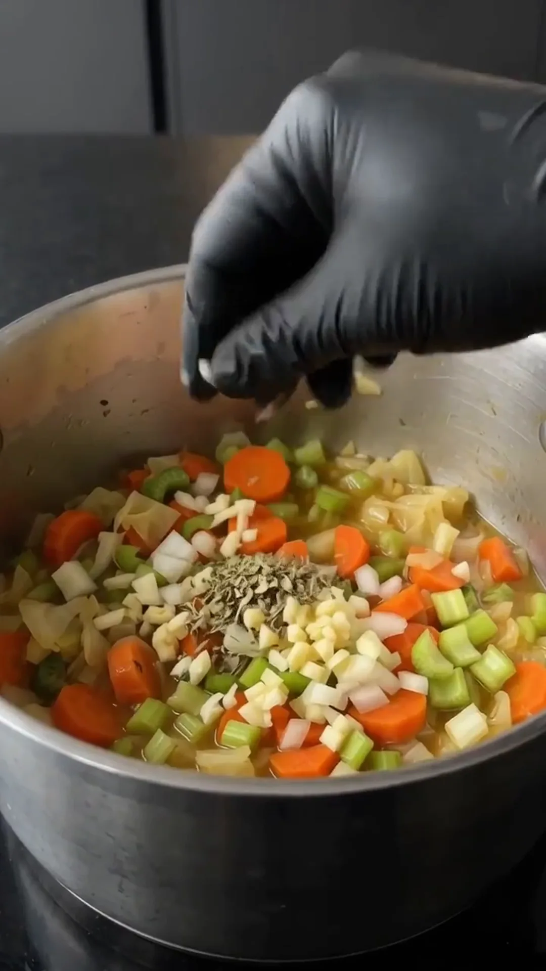 Comforting Homemade Cabbage Soup with Fresh Vegetables – Adding spices to soup