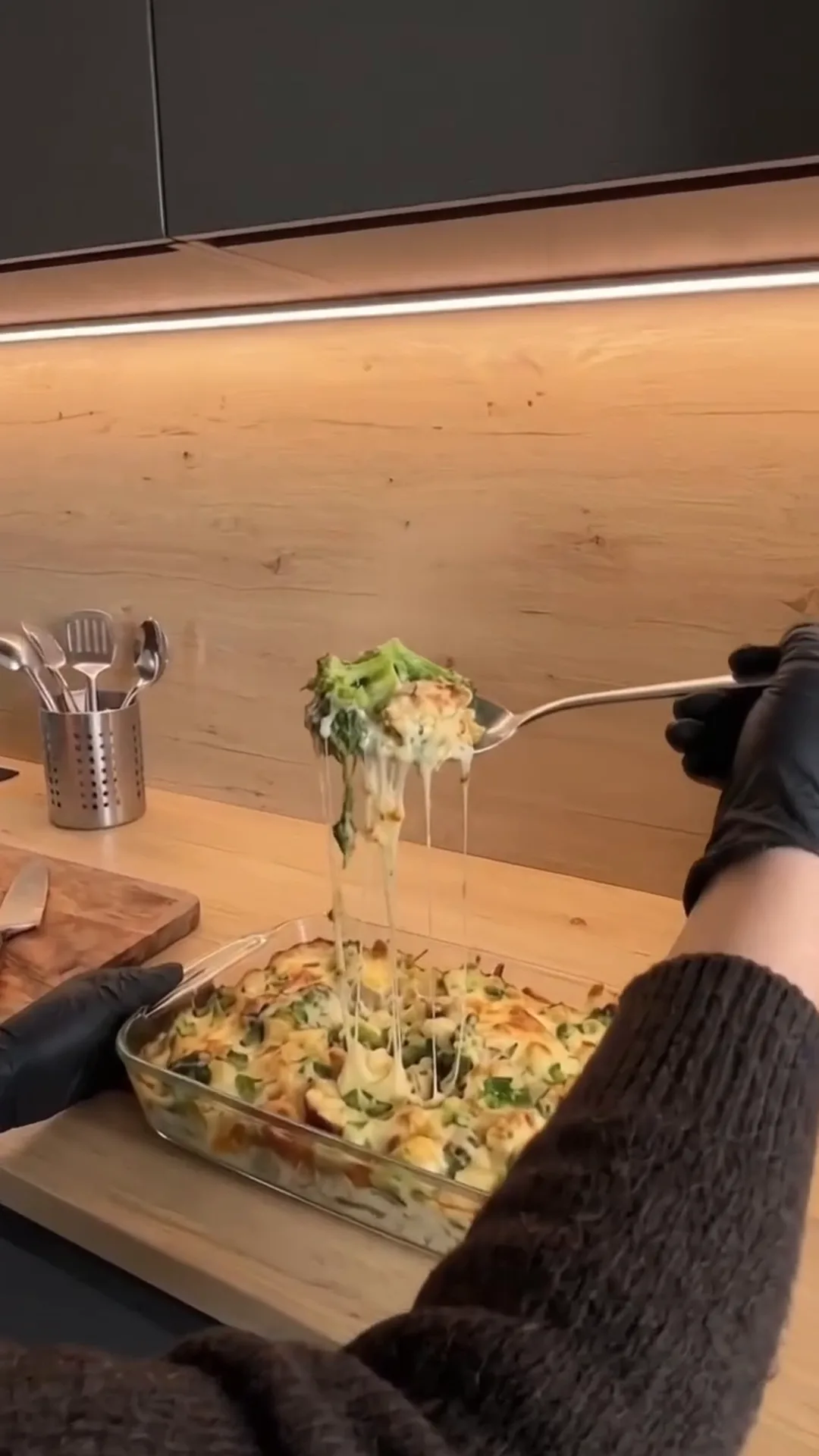 Creamy Low-Carb Chicken and Broccoli Alfredo Casserole – person is serving food from a casserole dish