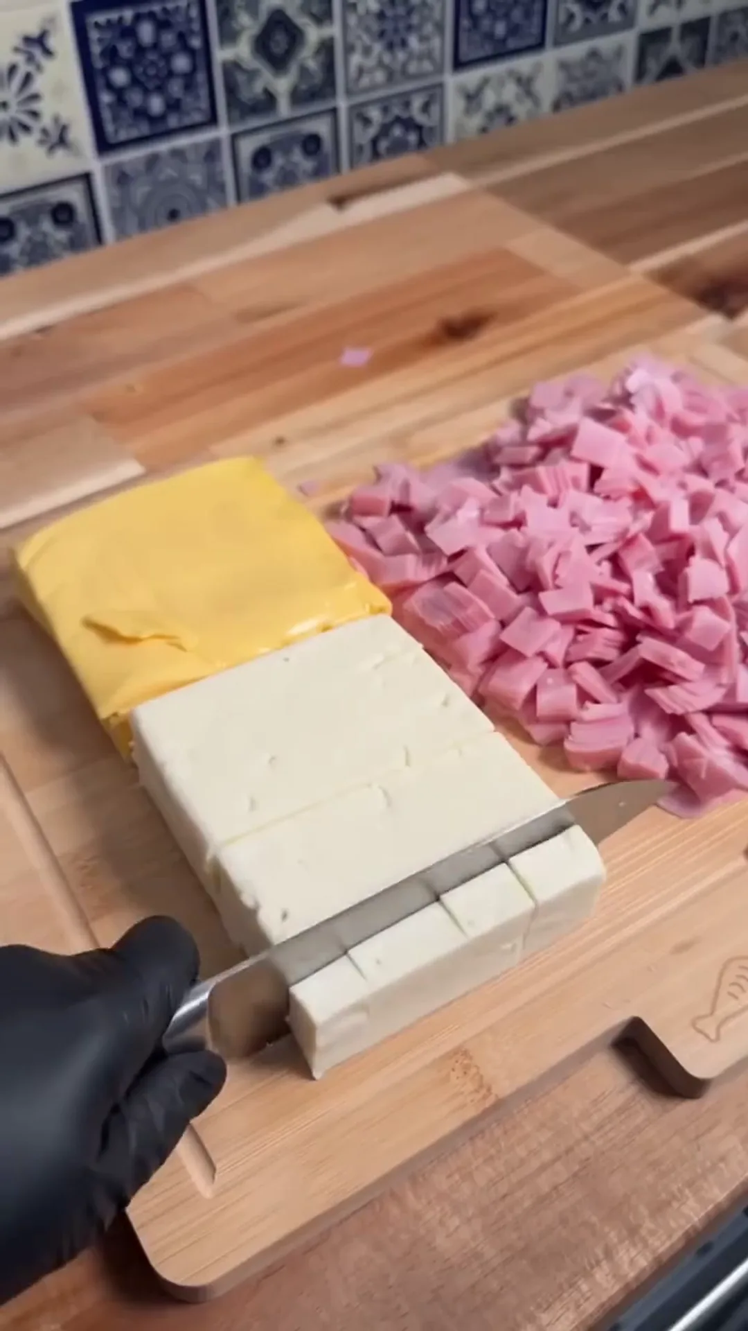 Creamy Mexican Party Sandwiches with Smoked Turkey – Someone is cutting cheese and smoked turkey on a wooden board