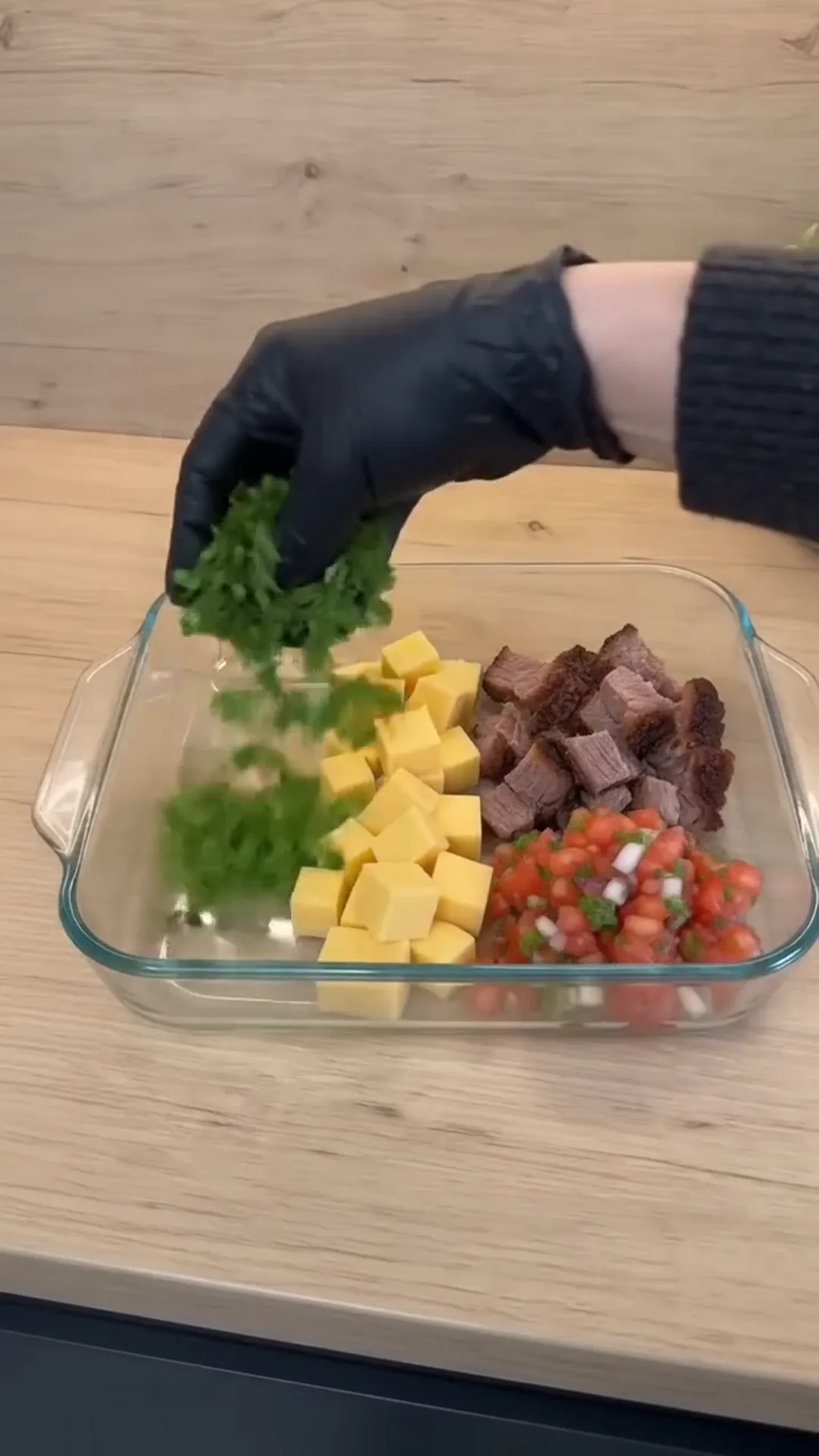 Creamy Smoked Brisket Queso Dip Recipe – person adding chopped green onions to a dish