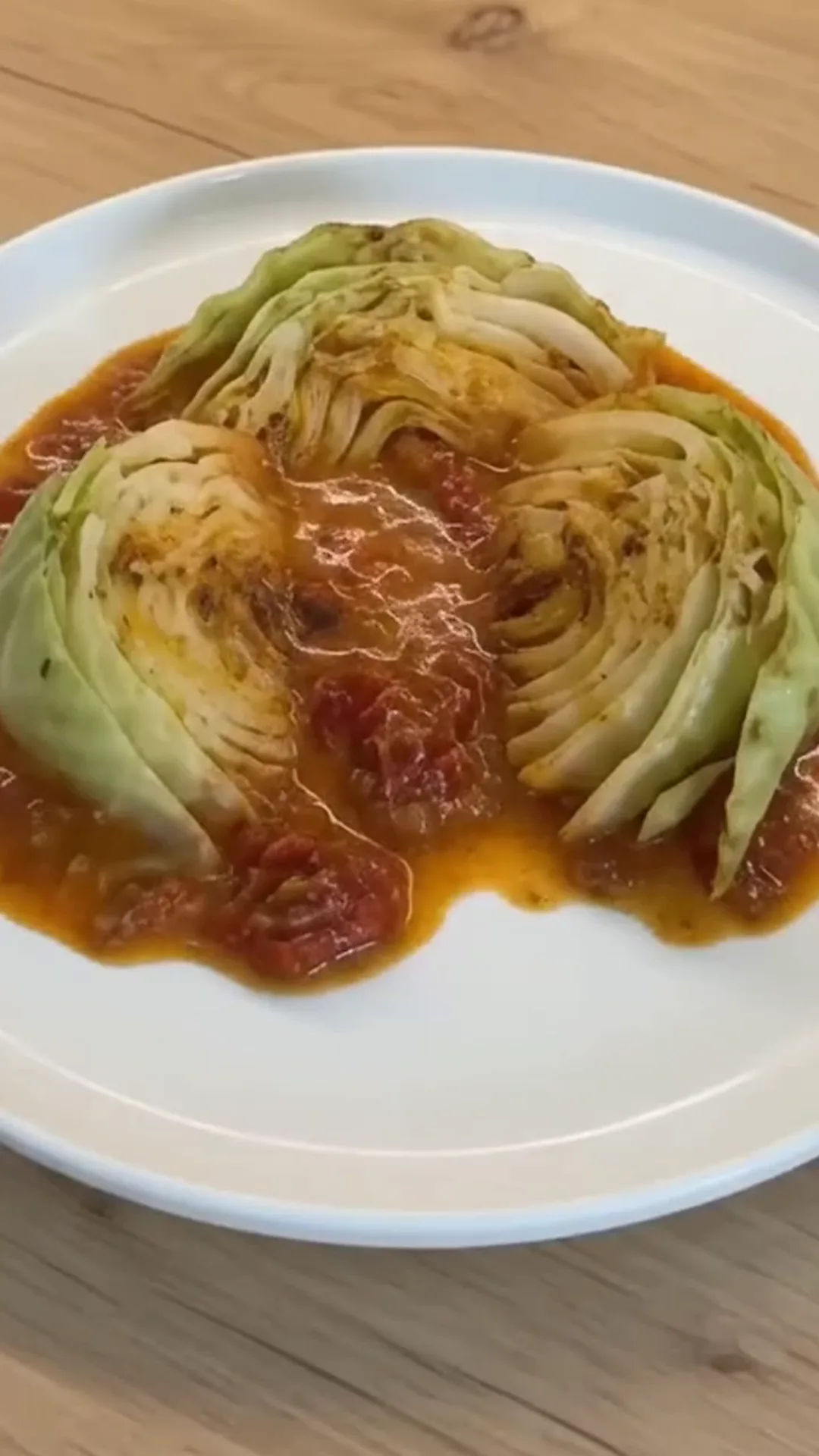 Creamy Sun-Dried Tomato Braised Cabbage Roasted Wedges – A person is cooking cabbage in a pan