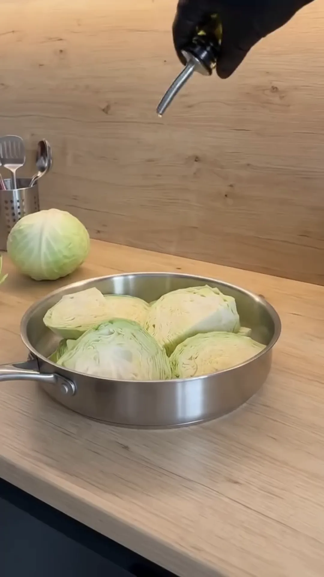 Creamy Sun-Dried Tomato Braised Cabbage Roasted Wedges – person pouring oil into a pan with cabbage