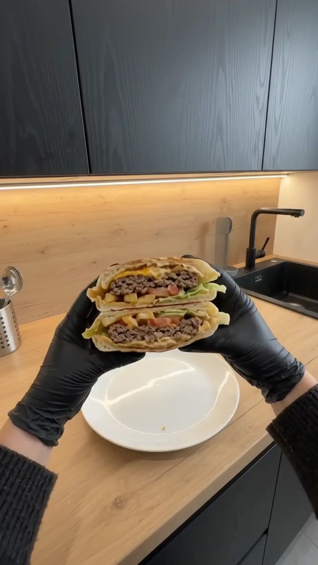 Crispy Cheeseburger Wrap with Golden French Fries – A person is holding a large burrito or wrap