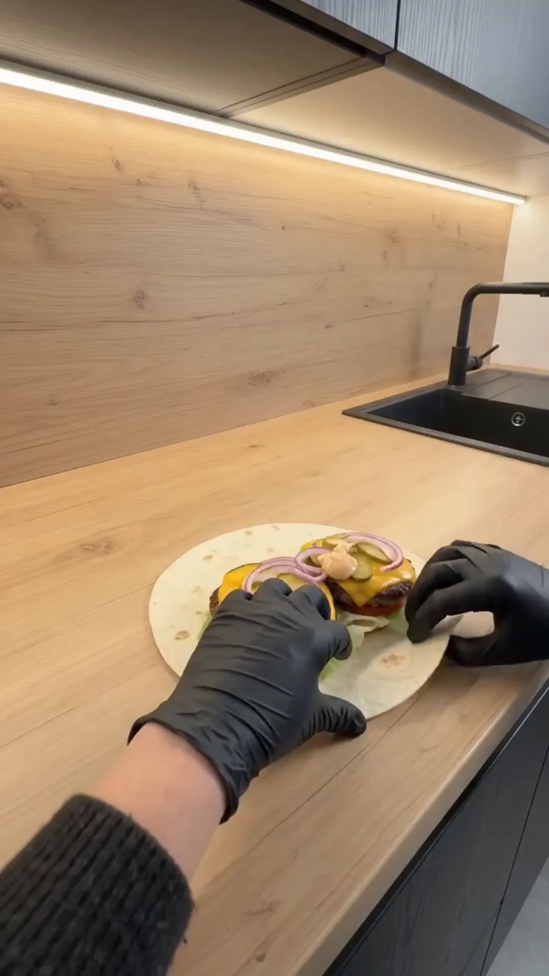 Crispy Cheeseburger Wrap with Golden French Fries – person assembling a burger on a tortilla
