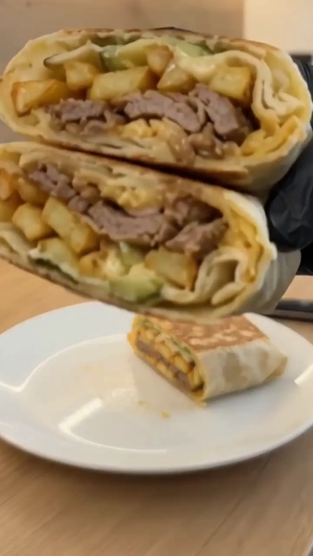 Crispy Cheeseburger Wrap with Golden French Fries – cutting a burrito