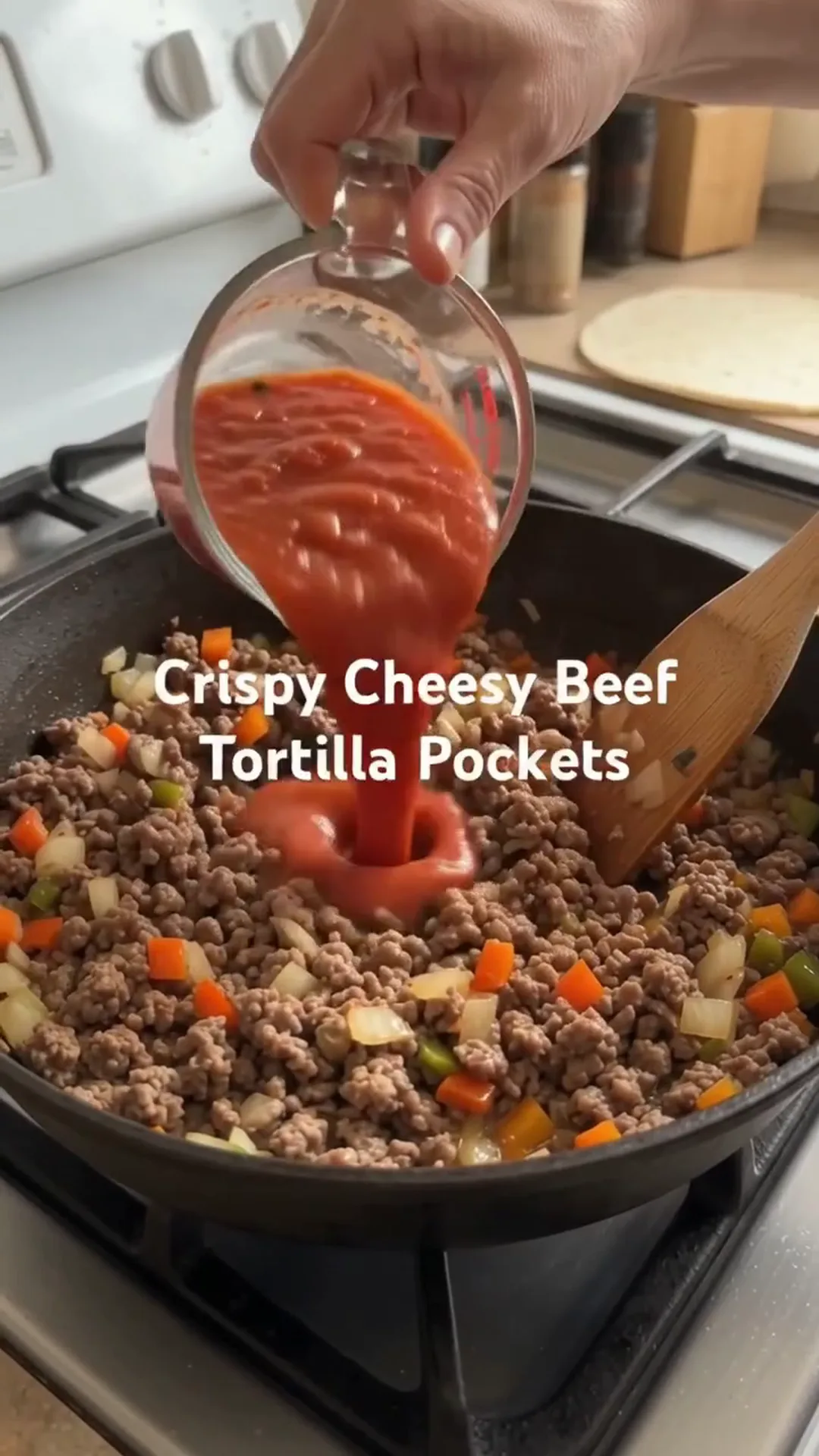 Crispy Cheesy Beef Tortilla Pockets Recipe – Pouring tomato sauce into a pan of ground beef