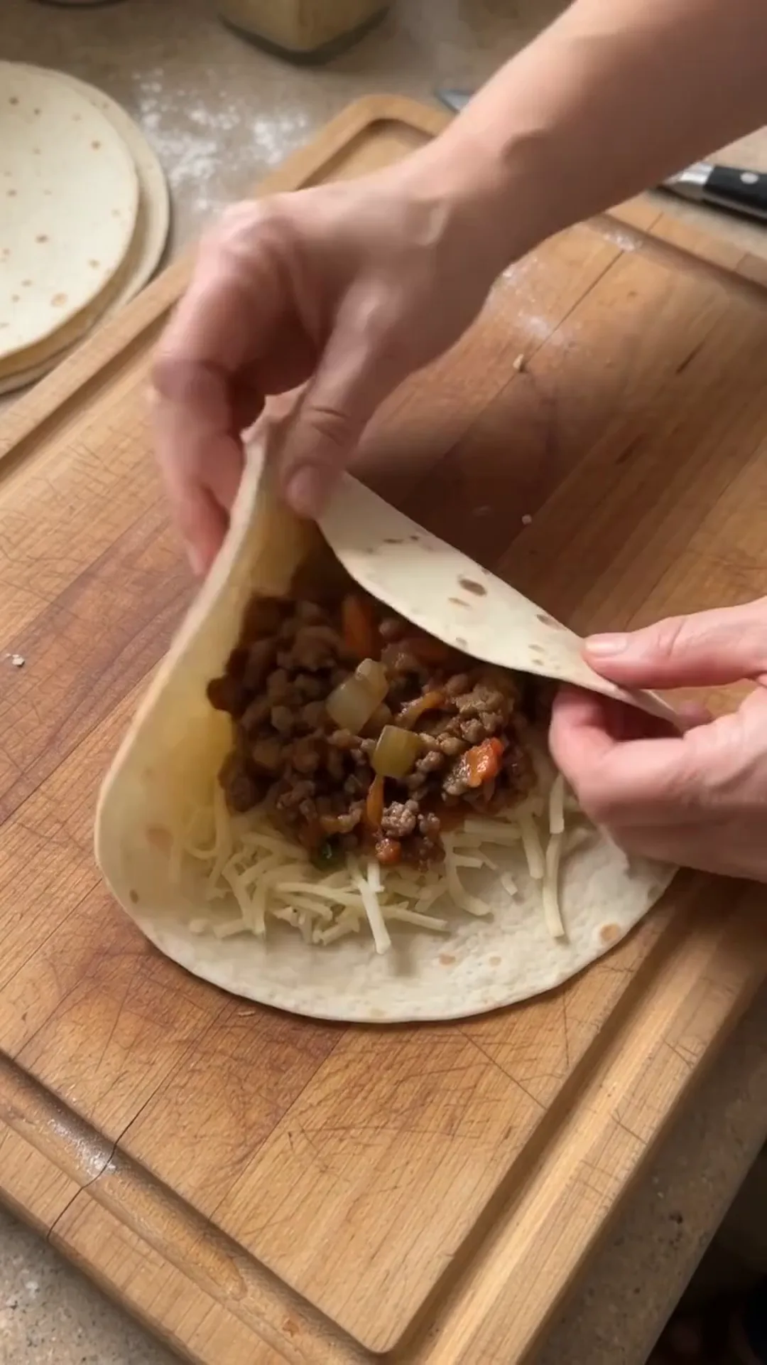 Crispy Cheesy Beef Tortilla Pockets Recipe – filling a tortilla with meat and cheese