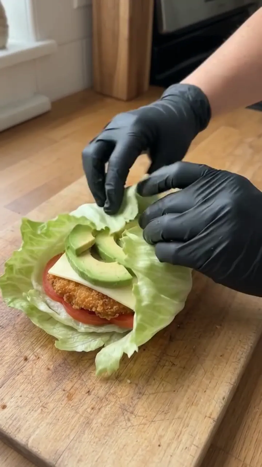 Crispy Chicken Lettuce Wraps with Avocado and Sauce – Hands preparing food