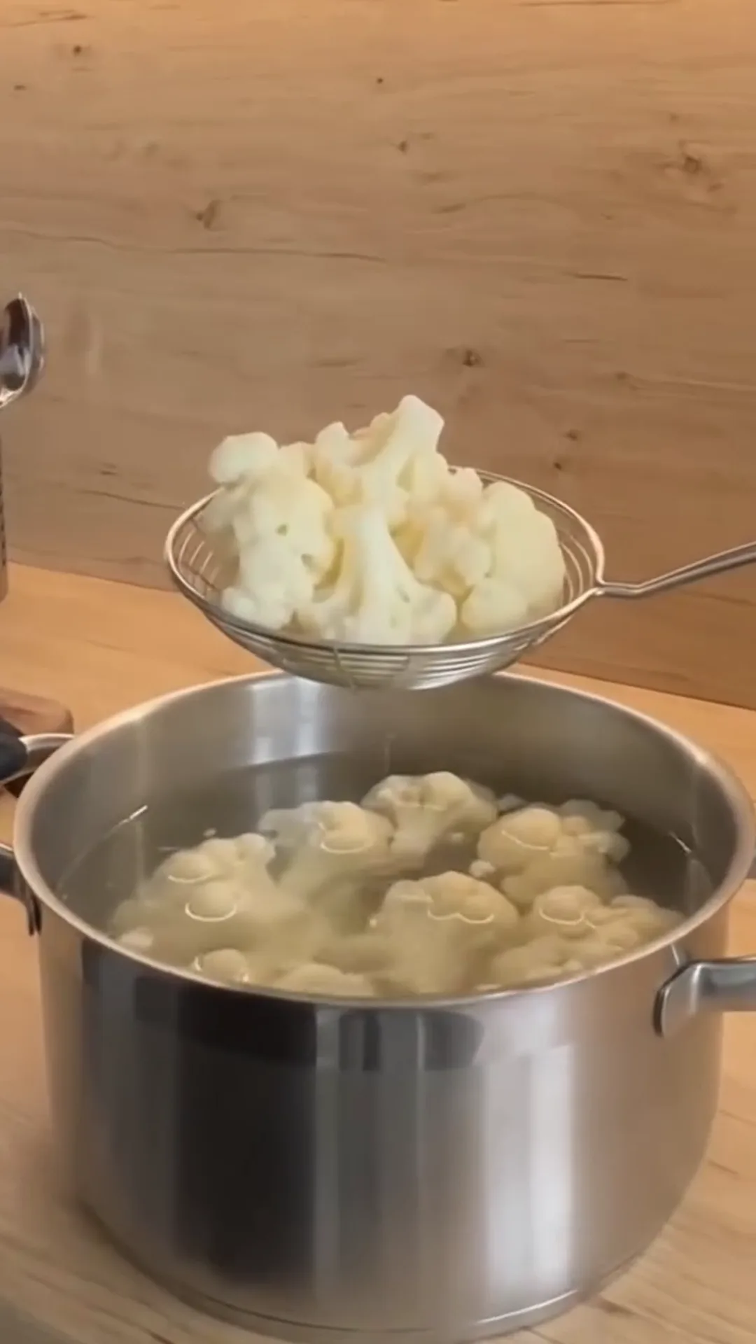 Crispy Oven-Baked Cauliflower Bites with Garlic Yogurt – Cauliflower being strained