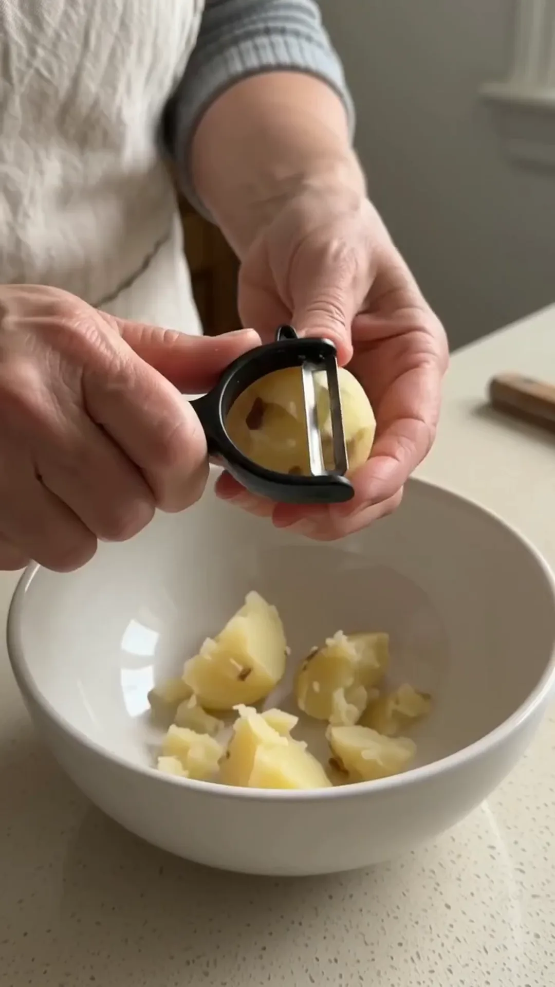 Crispy Potato Crust and Egg Breakfast Skillet Pizza – peeling potatoes with a peeler