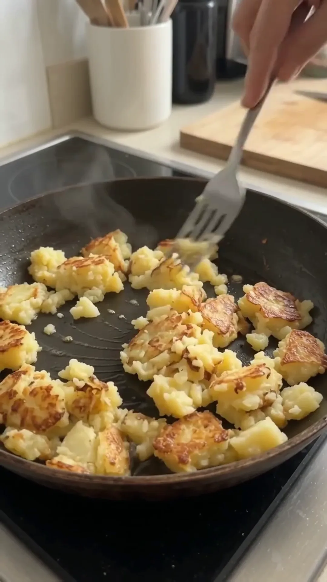 Crispy Potato Crust and Egg Breakfast Skillet Pizza – person is cooking potatoes in a pan
