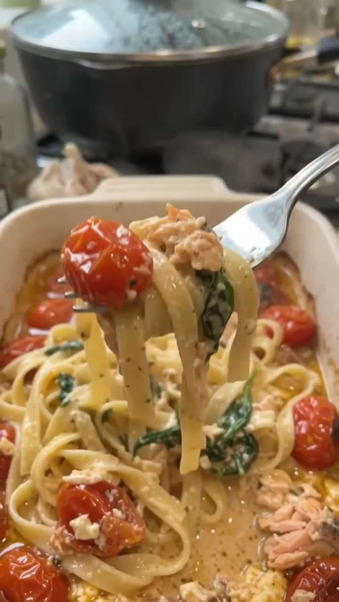 Easy Baked Salmon and Feta Pasta with Creamy Sauce – A fork is lifting pasta from a casserole dish