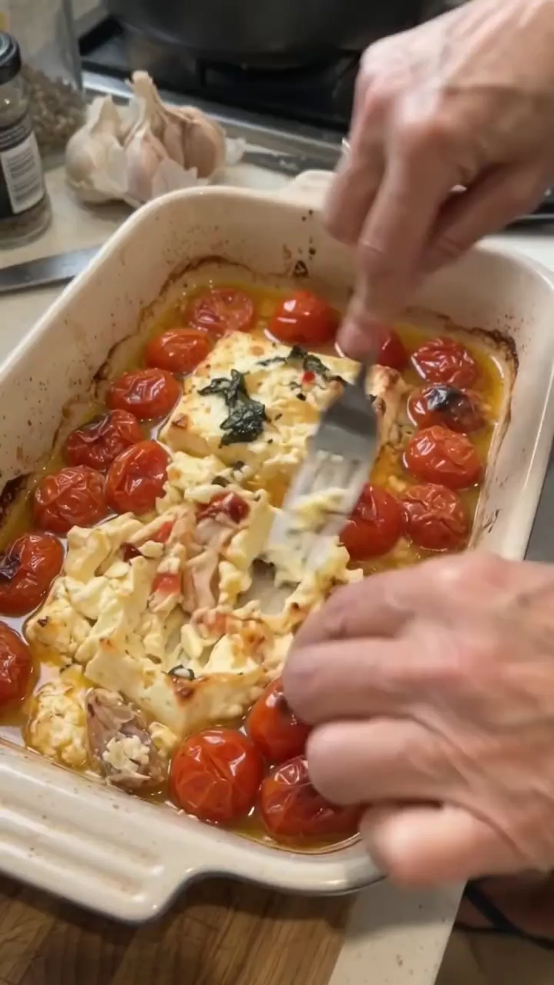 Easy Baked Salmon and Feta Pasta with Creamy Sauce – Someone is serving a dish from a baking tray