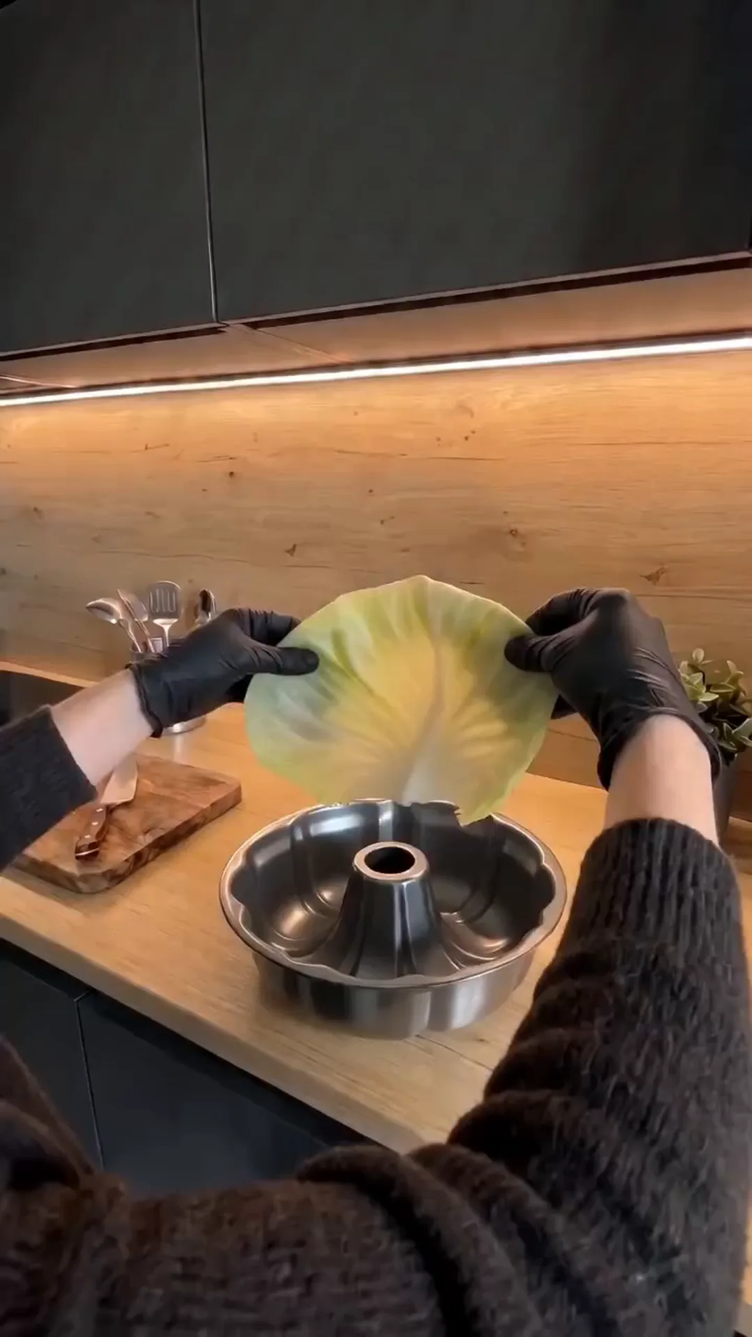 Easy Bundt Pan Cabbage Roll Ring with Beef and Rice – person preparing cabbage leaves for cooking