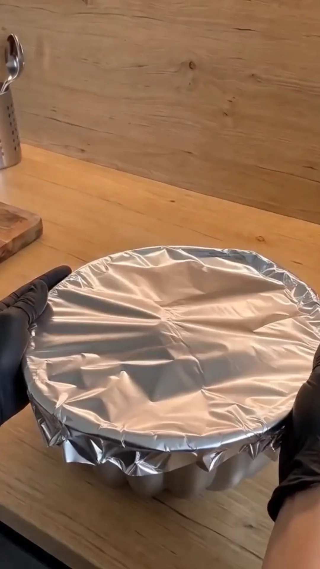 Easy Bundt Pan Cabbage Roll Ring with Beef and Rice – a person is covering a bowl with foil