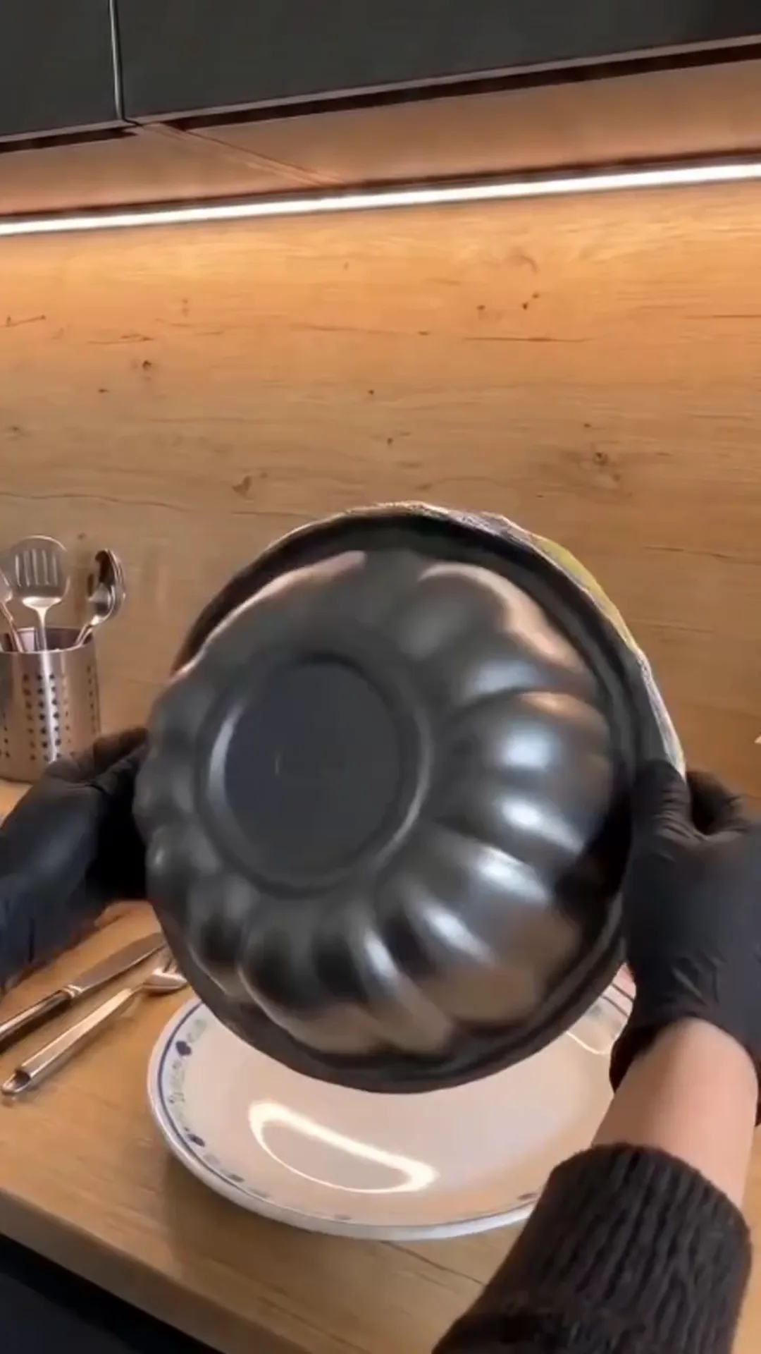 Easy Bundt Pan Cabbage Roll Ring with Beef and Rice – A person is holding a metal cake pan over a plate