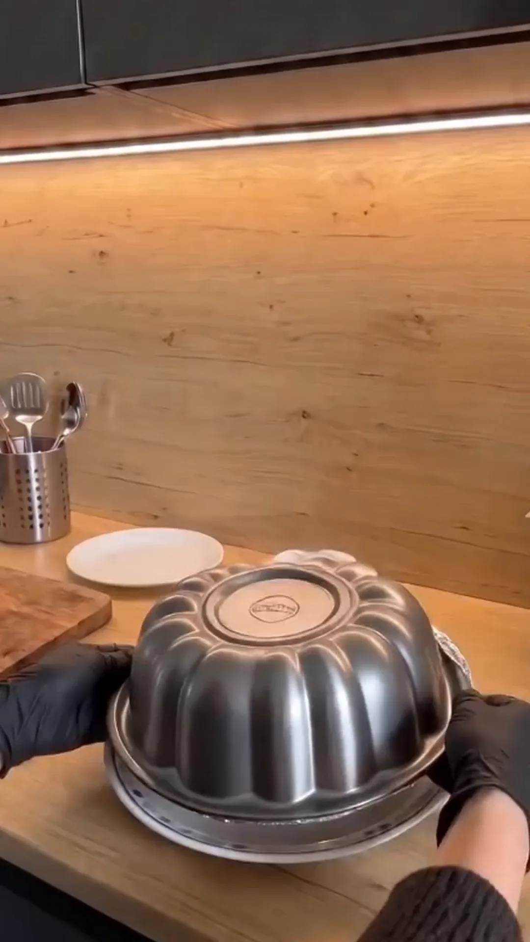 Easy Bundt Pan Cabbage Roll Ring with Beef and Rice – placing a metal cake pan on a plate