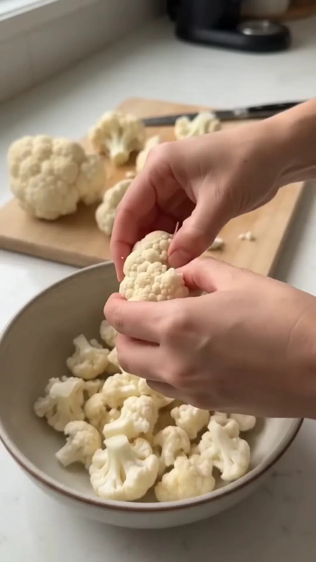 Easy Pan Fried Cauliflower and Eggs with Fresh Dill – peeling cauliflower florets, hands holding a piece