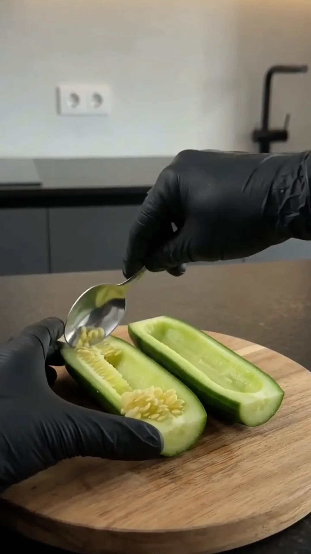 Easy Smoked Salmon Cucumber Sushi Boats – Someone is scooping out the seeds of a cucumber