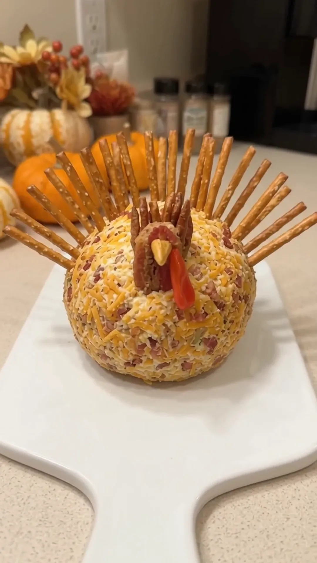 Festive Thanksgiving Turkey Cheese Ball with Crispy turkey bacon – A cheese ball shaped like a turkey is being made