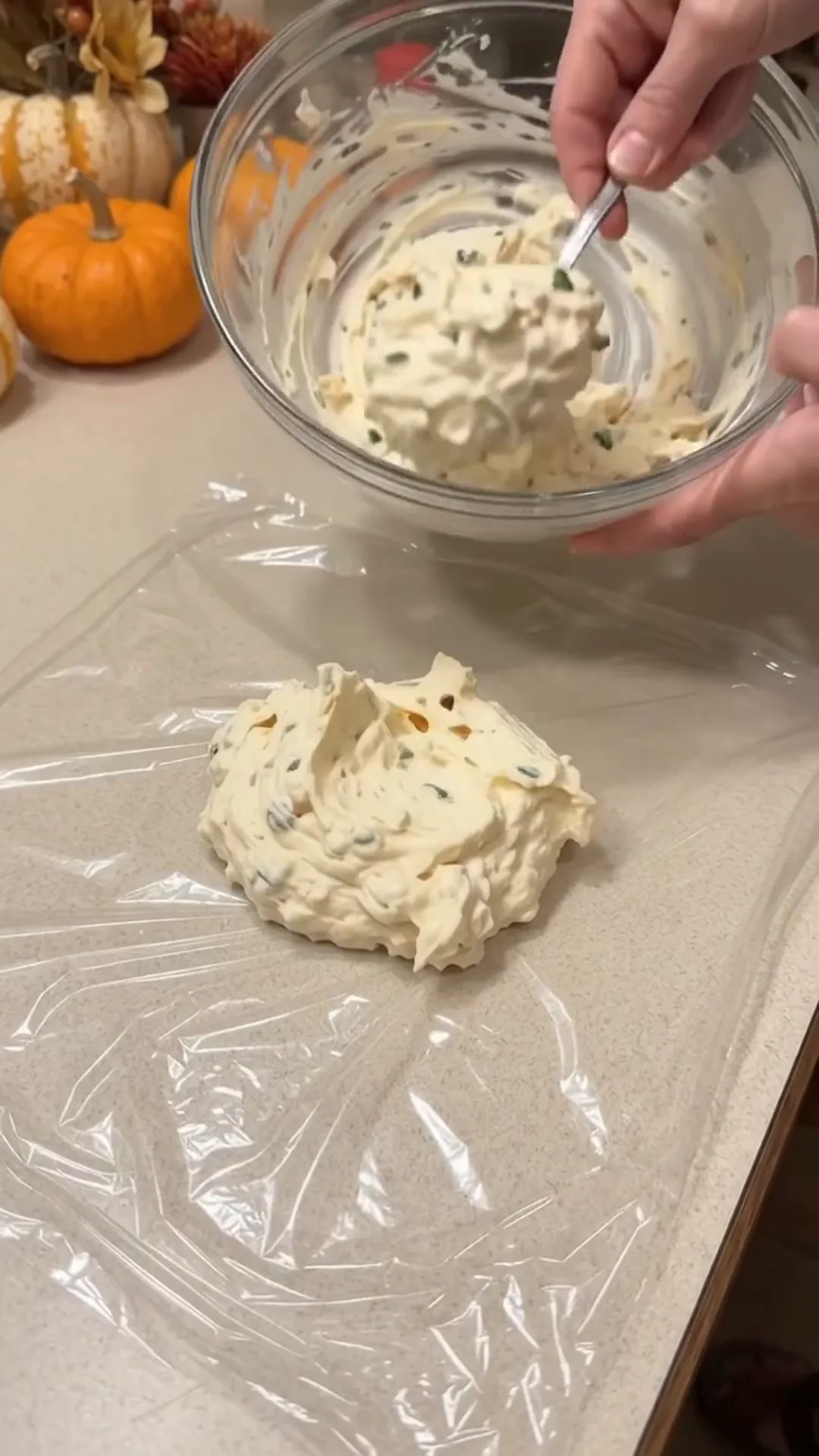 Festive Thanksgiving Turkey Cheese Ball with Crispy turkey bacon – person mixing cream cheese with herbs in a bowl