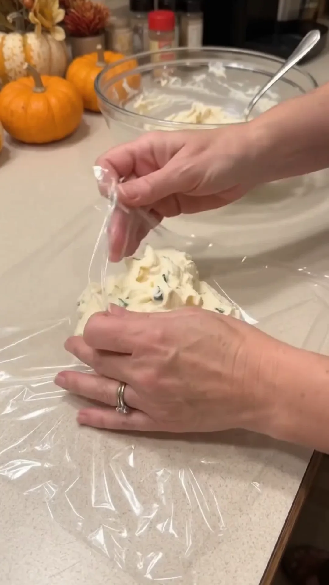 Festive Thanksgiving Turkey Cheese Ball with Crispy turkey bacon – woman sealing a bag of food with plastic wrap
