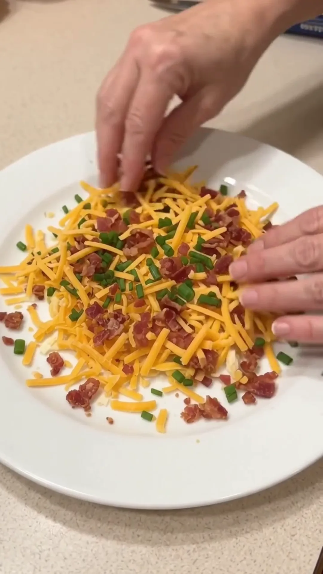 Festive Thanksgiving Turkey Cheese Ball with Crispy turkey bacon – Someone is adding cheese and bacon to a plate of food