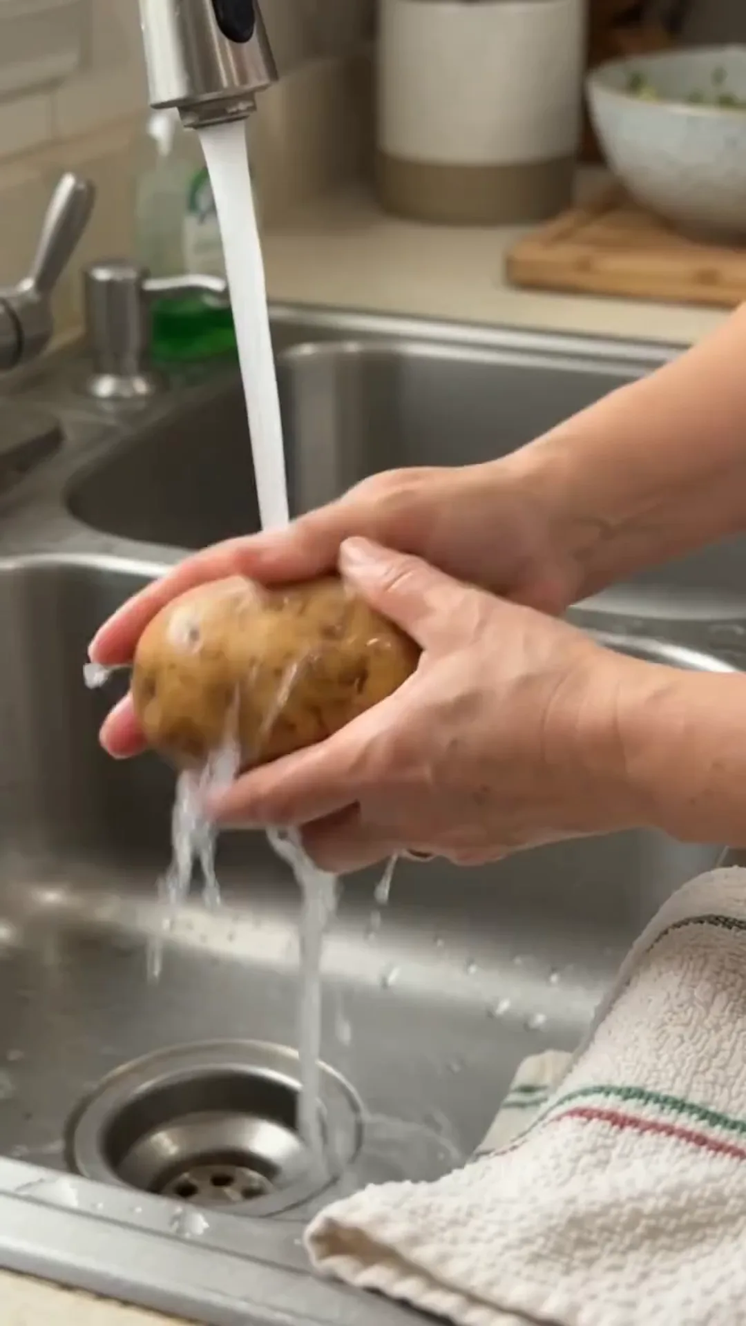 Garlic Butter Loaded Steak Baked Potatoes – washing a potato under running water