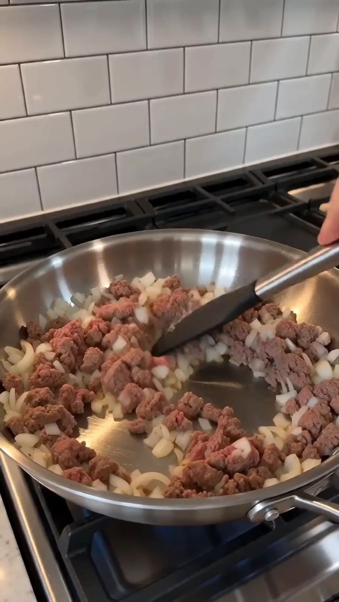 Golden Cheesy Baked Cabbage Steaks with Turkey Bacon – A person is cooking ground meat and onions in a pan