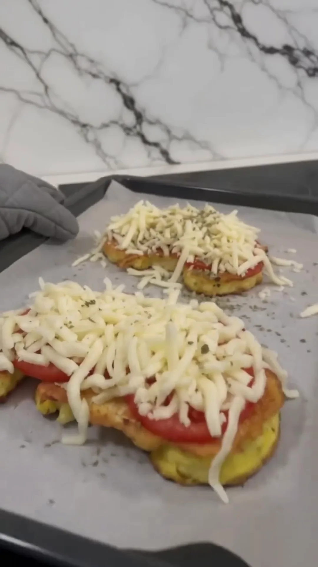 Golden Cheesy Tomato Cauliflower Steaks Recipe – Preparing mini pizzas, topping with cheese and tomato