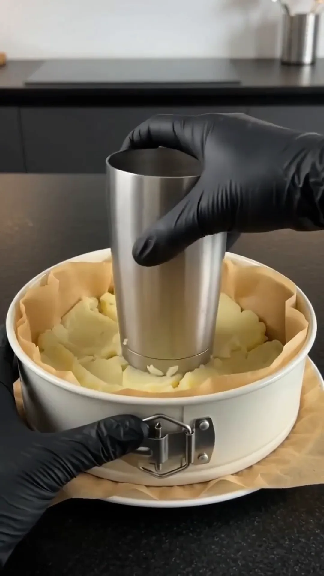 Hearty Cheesy Beef and Potato Crust Pie – pressing a metal cylinder into a cheesecake