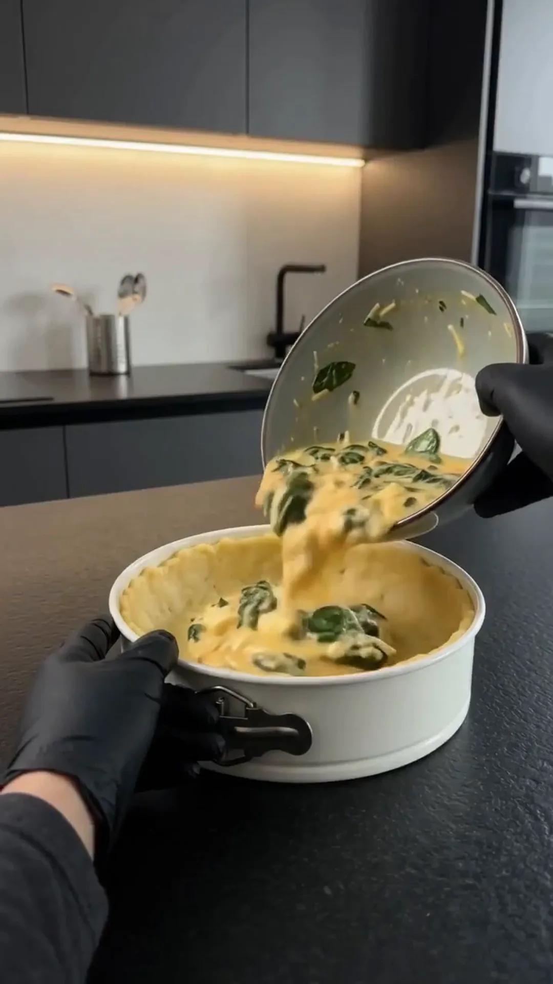 Hearty Cheesy Beef and Potato Crust Pie – Pouring a yellow sauce with green herbs into a pot