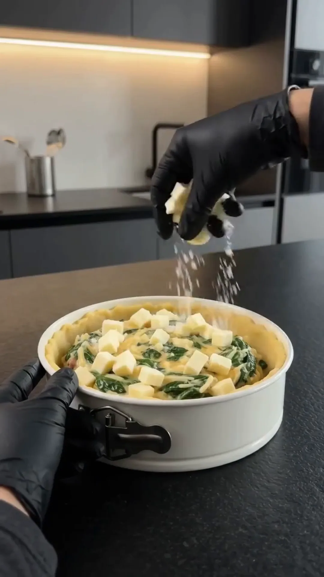Hearty Cheesy Beef and Potato Crust Pie – Sprinkling cheese on a dish in a kitchen