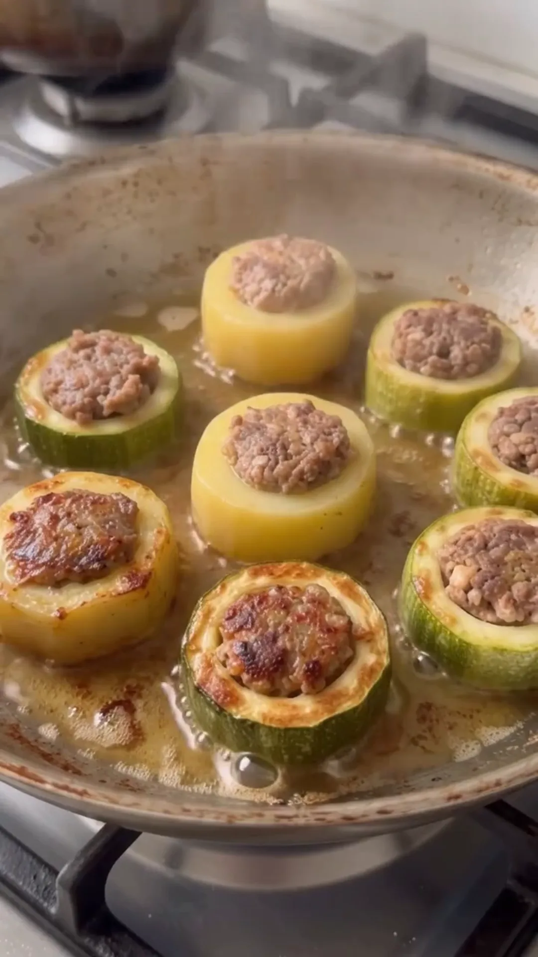 Hearty Meat-Stuffed Zucchini and Potato Bake – cooking stuffed zucchini in a pan