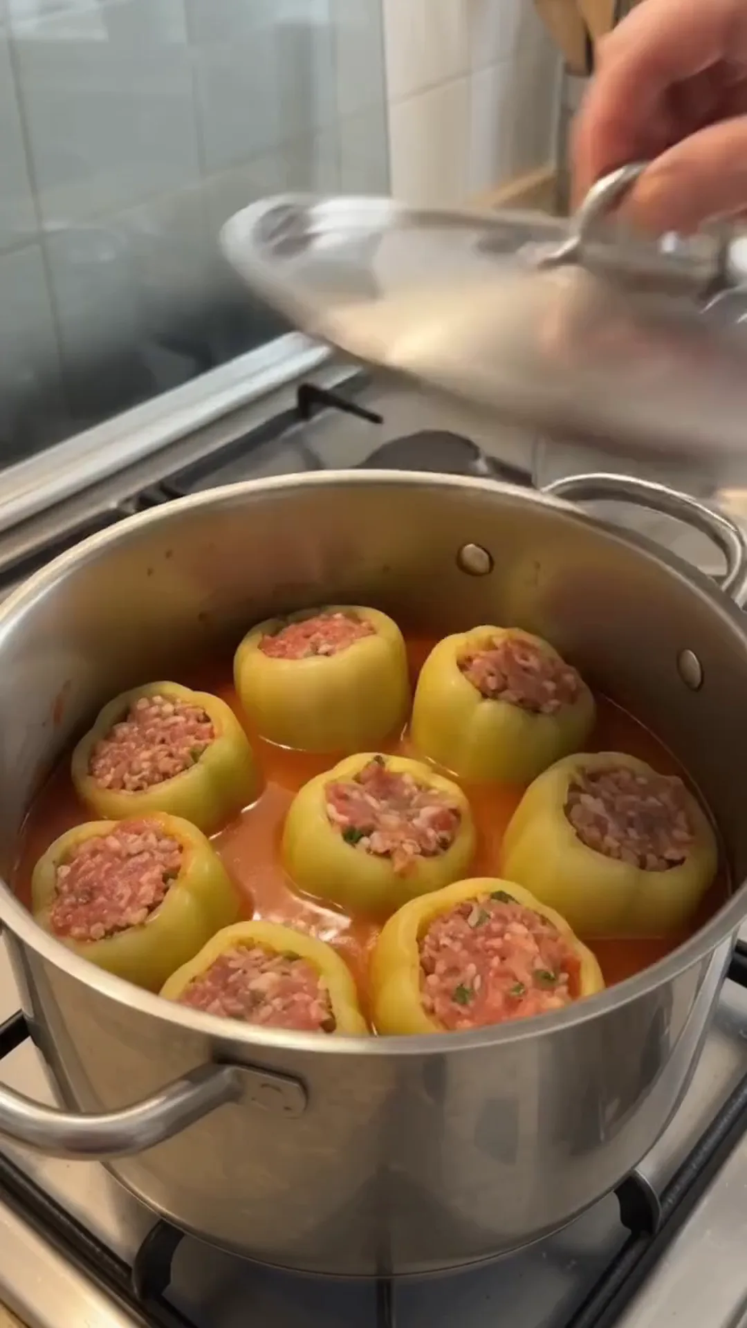 Hearty Stuffed Peppers with Beef and Rice over Mashed Potatoes – stuffed peppers being cooked in a pot