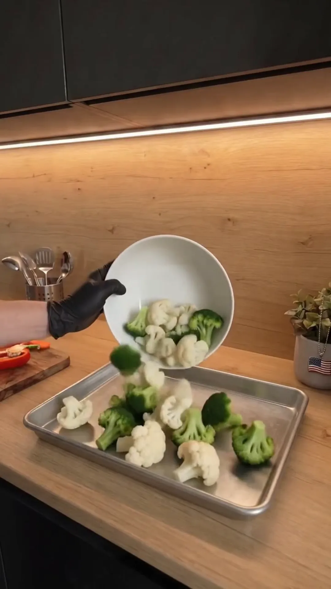 Herb-Roasted Mediterranean Vegetables with Garlic Yogurt – Pouring vegetables onto a baking tray