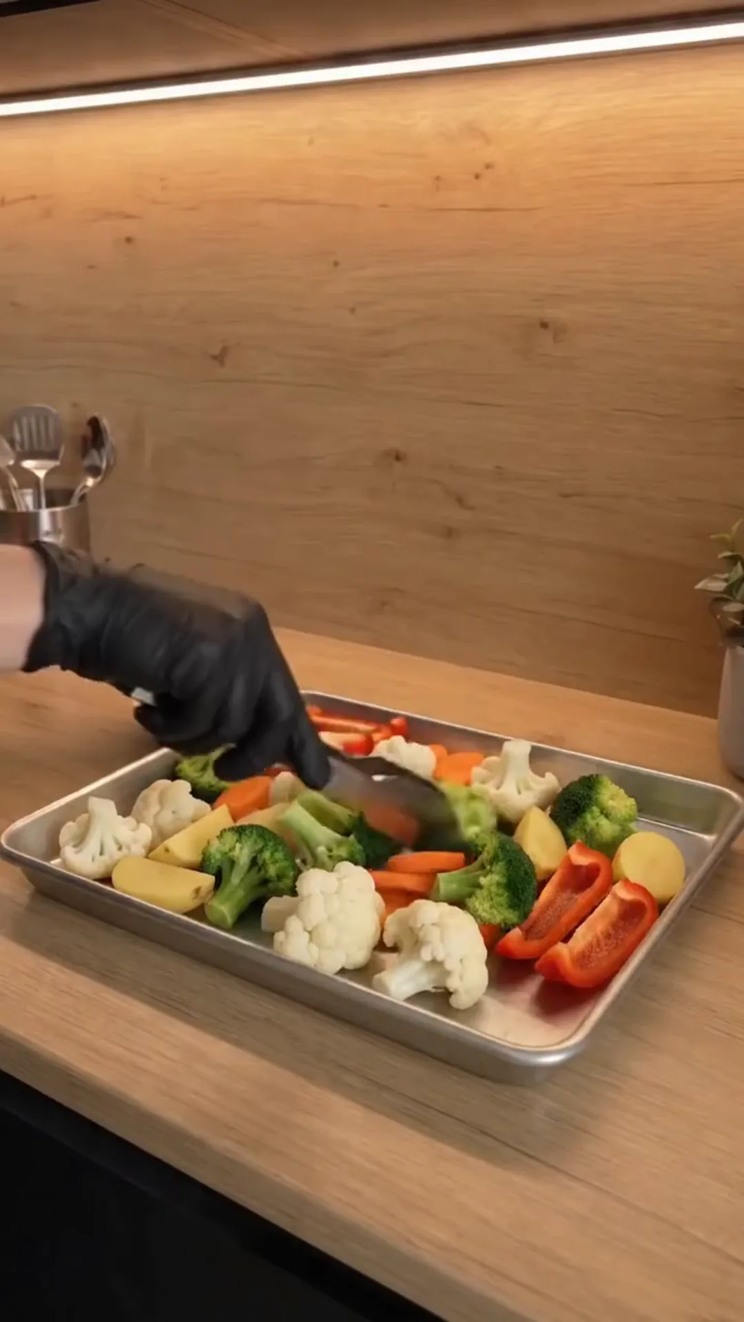 Herb-Roasted Mediterranean Vegetables with Garlic Yogurt – person placing vegetables on a baking tray