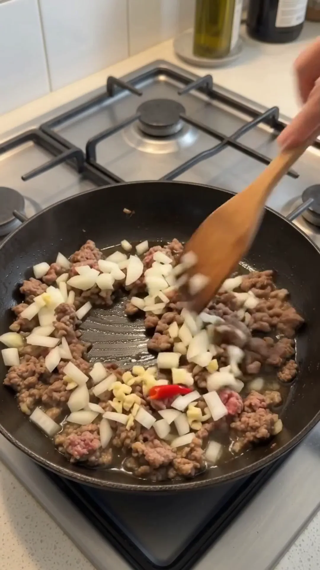 High Fiber Savory Cabbage and Ground Beef Skillet – stirring ground meat and onions in a pan